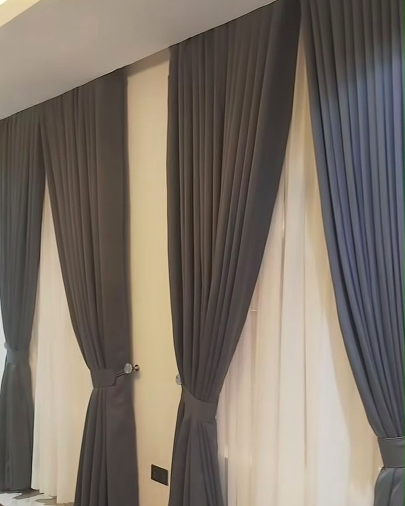 Charcoal drapes over ivory sheers
